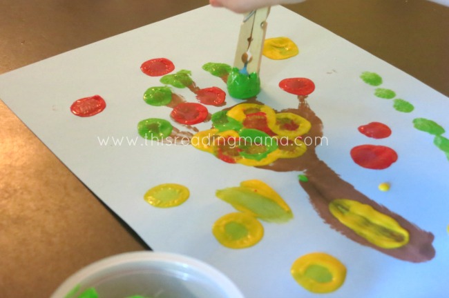 Using pom poms to paint apples | This Reading Mama