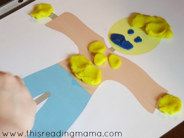 decorating the scarecrow from fall playdough mats