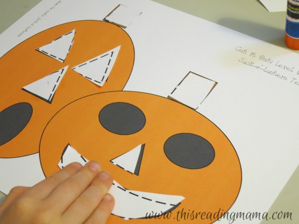 gluing down shapes to form a picture