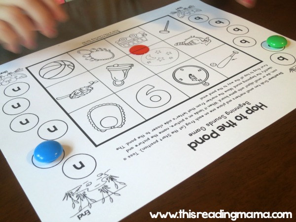 tossing manipulative on the beginning sounds game board
