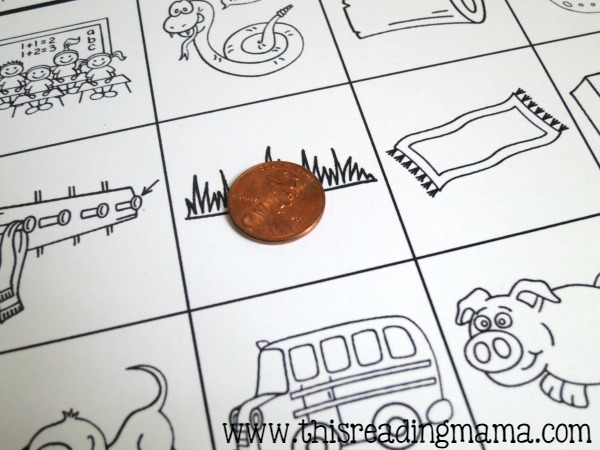 using a penny to toss on the ending sounds game boards