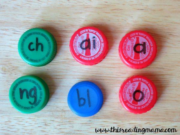 writing phonemes on bottle caps for spelling
